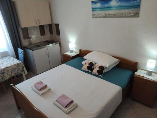 two dogs sitting on a bed in a room at Apartmani Mila-Casa Bianca in Medulin