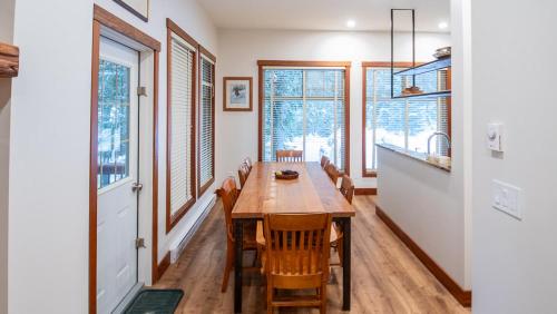 a dining room with a wooden table and chairs at Snow Creek Lodge by Fernie Lodging Co in Fernie