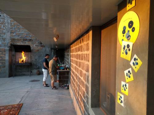 two men standing next to a wall with dice on it at Hill Station in Yerevan