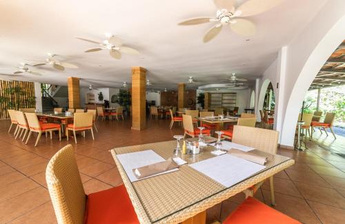 a dining room with tables and chairs and ceiling fans at Bella Luxury Suite in Coronado in Playa Coronado