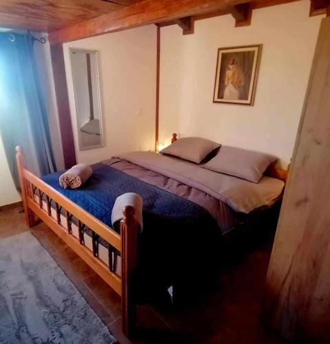 a bedroom with a large bed in a room at Kuća za odmor DRAVA LIFE in Molve