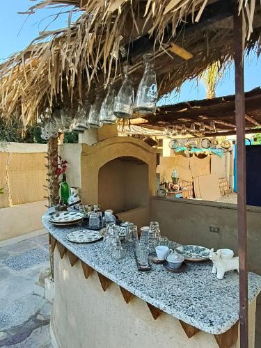 a table with plates and dishes on it in a patio at Motel moon in Tunis
