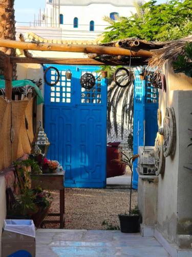 a blue door in front of a building at Motel moon in Tunis