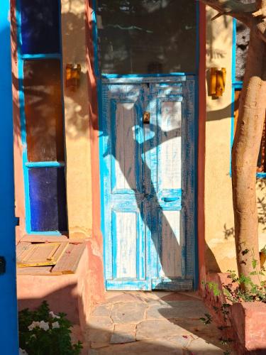 a blue door on the side of a building at Motel moon in Tunis