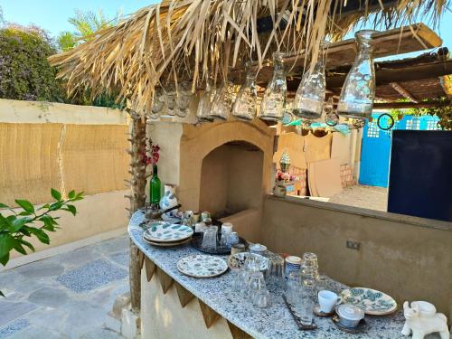 a table with plates and glasses on a patio at Motel moon in Tunis