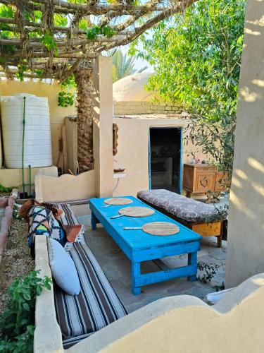 a patio with a blue table and a couch at Motel moon in Tunis