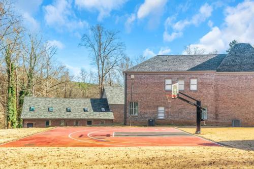 a basketball court in front of a brick building at The Panola Mansion - Indoor Pool & Pavilion in Stockbridge