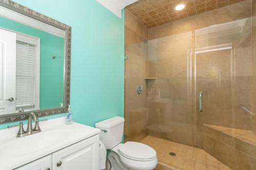 a bathroom with a toilet and a glass shower at The Panola Mansion - Indoor Pool & Pavilion in Stockbridge