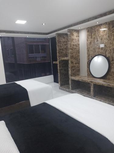 a bedroom with a bed and a large mirror at Hotel Gool de Guerrón in Quito