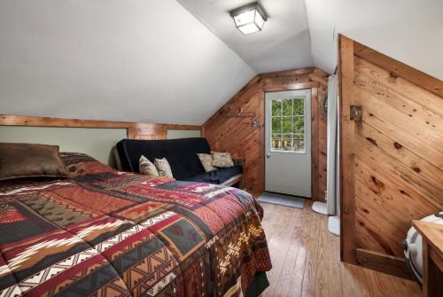 a bedroom with a bed and a couch at River Access Loft Deck WiFI & Pet Friendly in Great Cacapon