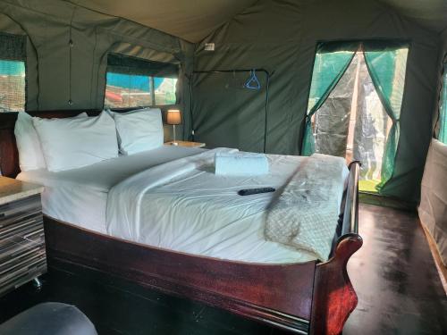 a bedroom with a bed in a tent at Tent On Manor in Durban