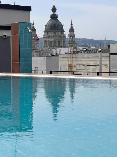 a large pool of water in front of a building at Luxe Studio in City Center with FREE Parking in Budapest