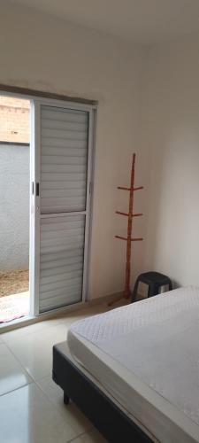 a bedroom with a door leading to a window at Casa suite airport in Campinas