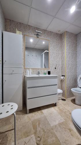 a bathroom with a sink and a mirror and a toilet at Loft céntrico en Ronda cercano al Tajo y Plaza de Toros con Wifi y Parking Opcional in Ronda