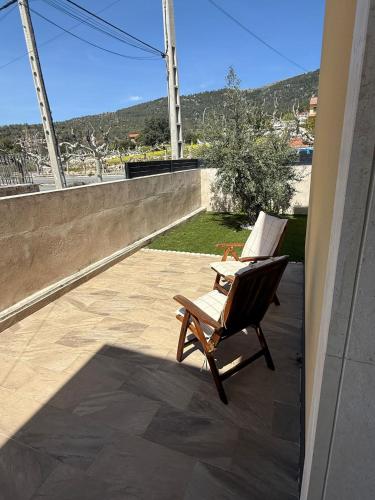 a rocking chair sitting on a patio with a view at La casa amarilla in El Barraco