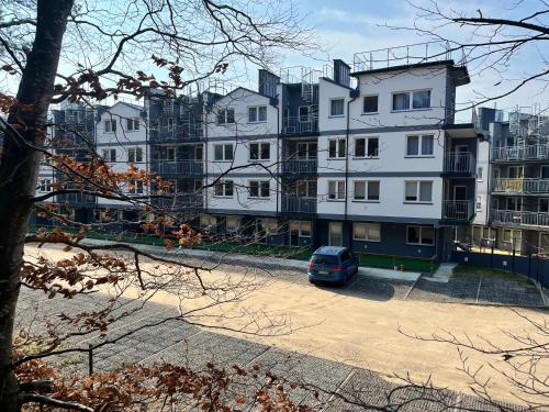a car parked in front of a building at Blue Apartment B, Dębina in Debina