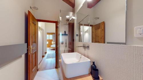 a bathroom with a white sink and a mirror at Abitaziun Guardaval 4 - Celerina in Celerina