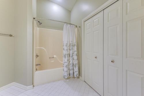 a white bathroom with a shower and a tub at Resort Condo about 2 Mi to Sunset Beach Seashore! in Sunset Beach
