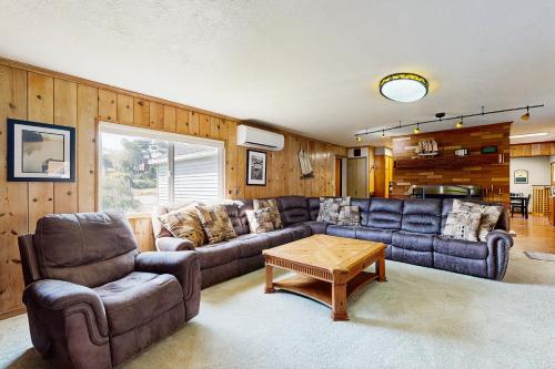 a living room with a couch and a table at Crescent Lake Lookout in Rockaway Beach