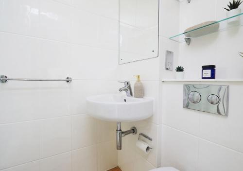 a white bathroom with a sink and a toilet at For Students Only Tower in Bristol in Bristol