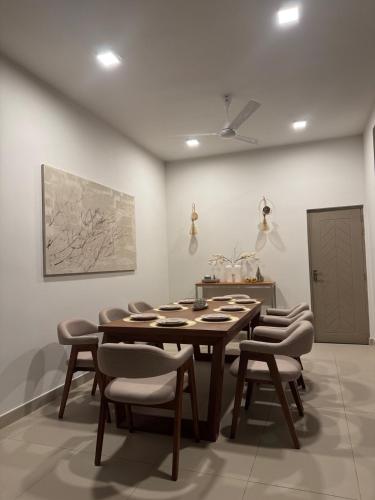 a dining room with a wooden table and chairs at Transit Designer Home in Negombo in Negombo