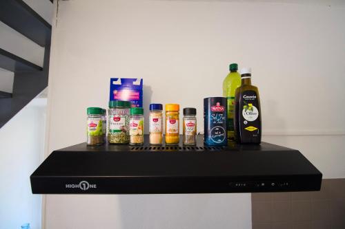 a shelf with a bunch of bottles of alcohol on it at Petit Duplex Lumineux, hyper centre à 2 pas du port, Intendance Luxury Host in Cherbourg en Cotentin
