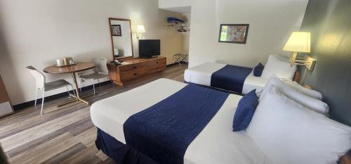 a hotel room with two beds and a table at Parkview Inn and Conference Center in Allentown