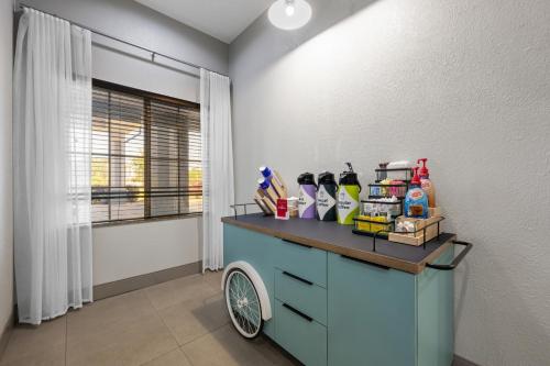 a room with a cart with food on it at Spark by Hilton Homewood Birmingham in Birmingham