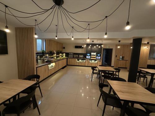 a restaurant with tables and chairs and a kitchen at Baltic Sun SPA in Rewal
