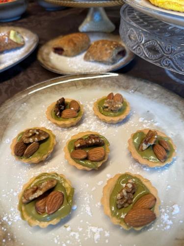 a plate of cookies with nuts on top of them at B&B Casa Benamati by Kelly in Malcesine