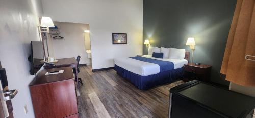 a hotel room with a bed and a television at Parkview Inn and Conference Center in Allentown
