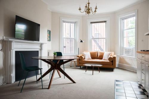 a living room with a couch and a table at Charming 1 Bedroom Newbury Street in Boston