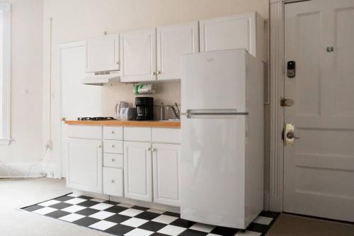 a white refrigerator in a kitchen with a checkered floor at Charming 1 Bedroom Newbury Street in Boston