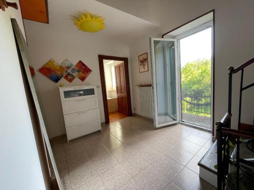 a kitchen with a window and a sink and a door at Casa CampoSelvatico in Valdena