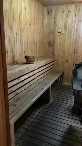 a wooden bench in a sauna with a bowl on it at Hotel Terrano Concepción in Concepción