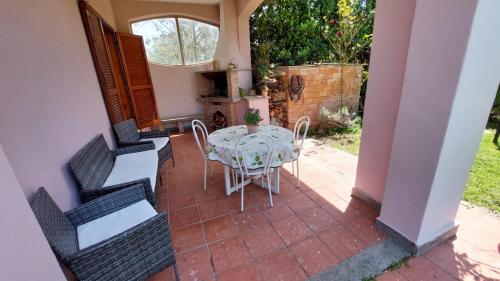 a patio with a table and chairs on a patio at Villa Damiano in Tarquinia