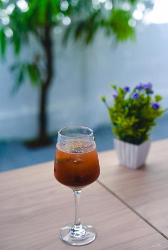 a drink in a glass sitting on a table at Tvessa by the Sea in Morjim