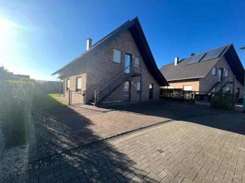 a brick building with a staircase on the side of it at Ferienwohnung direkt am See in Kalkar