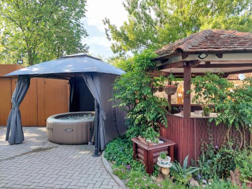 a garden with a gazebo and a hot tub at Vikendica Drinski mir in Loznica