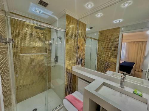 a bathroom with a shower and a sink and a mirror at The Palace Flat Moema - UH303 in Sao Paulo