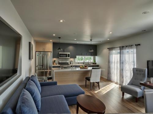 a living room with a blue couch and a kitchen at Hollywood Homes Free parking close to all things LA in Los Angeles