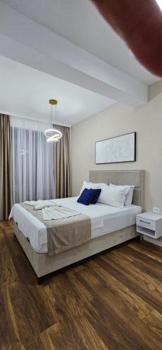 a bedroom with a large bed in a room at Bahr DELUX App & Suite in Ulcinj