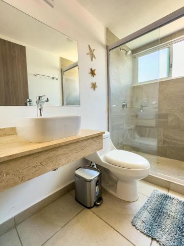 a bathroom with a sink and a toilet and a shower at Beautiful Apartment in Dream Acapulco Diamante in Acapulco
