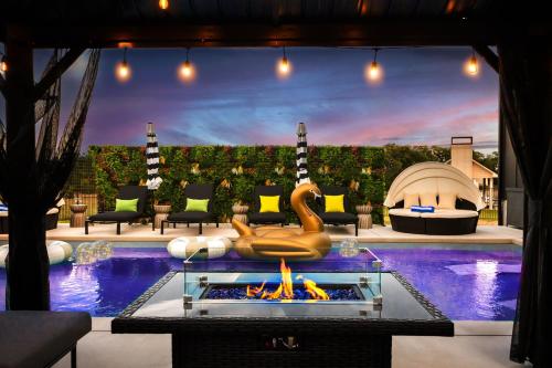 a room with a pool with a fire pit at Designer Home with Hot Tub BBQ & Hill Views in Driftwood