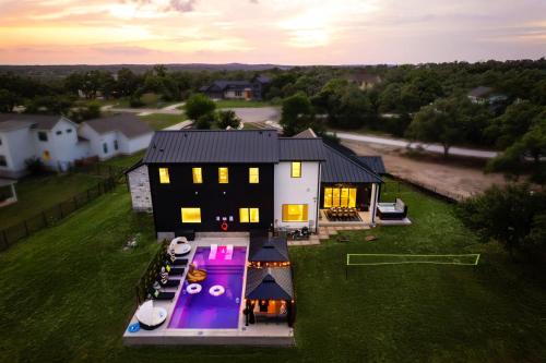 an aerial view of a house with a pool at Designer Home with Hot Tub BBQ & Hill Views in Driftwood