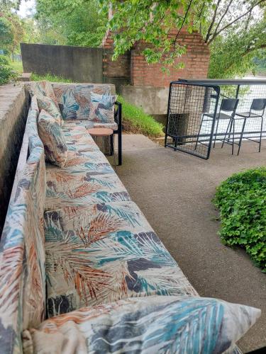 a long couch with a colorful blanket on it at Vikendica Drinski mir in Loznica