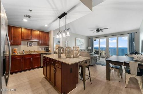 a kitchen and dining room with a view of the ocean at The Crab's Eyebrow in Panama City Beach