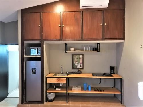 a kitchen with a desk and a refrigerator at Casa Rafaelita in Mérida