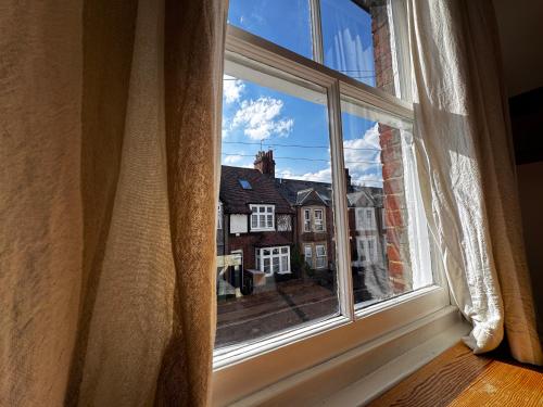 an open window with a view of a house at The OX1 in Oxford