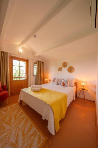 a large bedroom with two beds and a window at La Dia Hotel Faralya in Fethiye